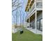 The backyard shows a well-manicured lawn and multi-level deck with multiple windows and sliding glass doors at 120 Huntcliff Pt, Atlanta, GA 30350