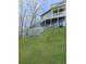 The backyard features a retaining wall, a well-manicured lawn, and a multi-level deck at 120 Huntcliff Pt, Atlanta, GA 30350