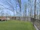 Level backyard featuring a freshly cut lawn and a black metal fence at 120 Huntcliff Pt, Atlanta, GA 30350
