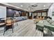 Expansive basement with stylish seating, wet bar, modern flooring and plenty of entertaining space at 120 Huntcliff Pt, Atlanta, GA 30350