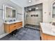 Modern bathroom featuring dual vanities, stylish mirrors, and a glass-enclosed shower at 120 Huntcliff Pt, Atlanta, GA 30350