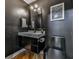 Modern powder room features black walls, floating vanity, and stylish fixtures at 120 Huntcliff Pt, Atlanta, GA 30350