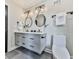 Modern bathroom featuring dual sinks, minimalist vanity, designer mirrors, and sleek fixtures at 120 Huntcliff Pt, Atlanta, GA 30350