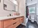 Modern bathroom featuring a floating vanity with a stylish mirror and hexagon tile flooring at 120 Huntcliff Pt, Atlanta, GA 30350