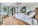Spacious bedroom with hardwood floors, modern ceiling fan, and access to an outdoor deck at 120 Huntcliff Pt, Atlanta, GA 30350