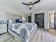 Bright bedroom with a decorative headboard, ceiling fan, and plank flooring at 120 Huntcliff Pt, Atlanta, GA 30350