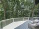 Relaxing deck featuring chairs, and scenic views of the lush trees at 120 Huntcliff Pt, Atlanta, GA 30350