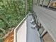 This deck features an outdoor seating area with a view of the surrounding trees and lush greenery at 120 Huntcliff Pt, Atlanta, GA 30350