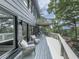 Wraparound deck with ample seating areas and views of the wooded landscape at 120 Huntcliff Pt, Atlanta, GA 30350