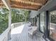 Spacious deck with outdoor seating and a view of the surrounding trees at 120 Huntcliff Pt, Atlanta, GA 30350