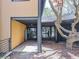 Side entrance features a covered walkway, architectural details, and landscaped surroundings at 120 Huntcliff Pt, Atlanta, GA 30350