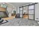 Elegant entryway featuring a stone floor, sliding glass doors, and staircase to the upper level at 120 Huntcliff Pt, Atlanta, GA 30350
