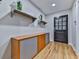 Bright entryway with wood floors, decorative shelving, and a black front door at 120 Huntcliff Pt, Atlanta, GA 30350