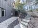 Stone steps lead to the side of the house with thoughtful landscape lighting at 120 Huntcliff Pt, Atlanta, GA 30350