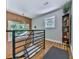 Bright hallway with modern railing, hardwood floors, and decorative shelving at 120 Huntcliff Pt, Atlanta, GA 30350