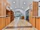 Open-concept kitchen with custom wood cabinets and an open view into the living room at 120 Huntcliff Pt, Atlanta, GA 30350