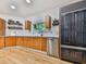 Bright kitchen featuring wood cabinets, stainless steel appliances, and hardwood flooring at 120 Huntcliff Pt, Atlanta, GA 30350