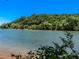 Beautiful lakeside view with lush greenery, showcasing the property's scenic waterfront location at 120 Huntcliff Pt, Atlanta, GA 30350