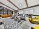 Spacious living room with vaulted ceiling, exposed beams, and comfortable seating arrangement at 120 Huntcliff Pt, Atlanta, GA 30350
