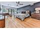 Spacious main bedroom featuring a private deck, hardwood floors, and dark accent wall at 120 Huntcliff Pt, Atlanta, GA 30350