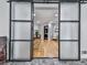 View of a home office with sleek sliding doors and hardwood floors at 120 Huntcliff Pt, Atlanta, GA 30350