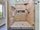 Modern shower with custom tile, black fixtures, and pebble stone floor at 120 Huntcliff Pt, Atlanta, GA 30350