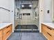 Luxurious bathroom shower boasts black hexagon tile floor, rainfall shower head and bench seating at 120 Huntcliff Pt, Atlanta, GA 30350