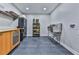 Well-lit utility room with grey floors, stainless steel sink, and ample storage at 120 Huntcliff Pt, Atlanta, GA 30350