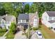 An aerial view reveals a two-story home with a two-car garage, manicured landscaping, and a tree-lined street at 1379 Vintage Pointe Dr, Lawrenceville, GA 30044