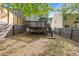 This backyard with a wood fence features a large gray deck and space for outdoor activities at 1379 Vintage Pointe Dr, Lawrenceville, GA 30044