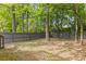 This backyard features a wood fence and lush green trees, providing privacy at 1379 Vintage Pointe Dr, Lawrenceville, GA 30044