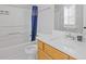 This full bathroom is equipped with a shower and tub, a vanity sink with storage, and a window at 1379 Vintage Pointe Dr, Lawrenceville, GA 30044