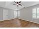 Spacious bedroom featuring hardwood floors, ceiling fan, trey ceilings, and large windows at 1379 Vintage Pointe Dr, Lawrenceville, GA 30044