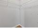 Spacious walk-in closet featuring storage racks and hardwood floors at 1379 Vintage Pointe Dr, Lawrenceville, GA 30044