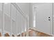 Entryway featuring hardwood floors, white trim, and staircase with a view of the front door at 1379 Vintage Pointe Dr, Lawrenceville, GA 30044