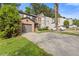 View of a two-story townhouse with a brick facade, driveway, and lush green landscaping at 1379 Vintage Pointe Dr, Lawrenceville, GA 30044