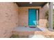 Close-up of a vibrant turquoise front door of a brick home with sidelight window at 1379 Vintage Pointe Dr, Lawrenceville, GA 30044