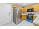 Bright kitchen features stainless steel appliances, ample cabinet space, and marble tile floors at 1379 Vintage Pointe Dr, Lawrenceville, GA 30044