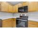 Well-lit kitchen with light wood cabinets, modern appliances, and light colored countertop at 1379 Vintage Pointe Dr, Lawrenceville, GA 30044