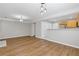 Open living space featuring hardwood floors, modern lighting, and a view into the kitchen at 1379 Vintage Pointe Dr, Lawrenceville, GA 30044