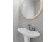 A modern powder room featuring a pedestal sink, sleek faucet, and an oval mirror at 1379 Vintage Pointe Dr, Lawrenceville, GA 30044