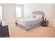Spacious bedroom featuring a plush queen-sized bed with a tufted headboard and neutral-toned bedding at 3851 Bogan Mill Rd, Buford, GA 30519