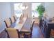 Traditional dining room with dark wood floors, a large dining table, and bright natural light from the two windows at 3851 Bogan Mill Rd, Buford, GA 30519