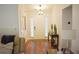 Bright foyer featuring dark wood floors, a white front door with sidelights, and a small table for decor at 3851 Bogan Mill Rd, Buford, GA 30519