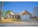Charming single-story home with stone facade, manicured lawn, and attached two-car garage at 3851 Bogan Mill Rd, Buford, GA 30519