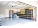 Spacious garage with epoxy floor, storage cabinets, stainless steel refrigerator, and plastic storage containers at 3851 Bogan Mill Rd, Buford, GA 30519
