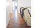 Hallway with dark wood floors and a view into the living room and an adjacent room at 3851 Bogan Mill Rd, Buford, GA 30519