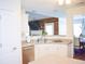 Eat-in kitchen featuring white cabinets, stainless steel appliances, and neutral countertops, adjacent to a dining area at 3851 Bogan Mill Rd, Buford, GA 30519