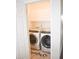 Convenient laundry room with modern washer and dryer, overhead cabinets, and stylish Laundry Co. floor mat at 3851 Bogan Mill Rd, Buford, GA 30519