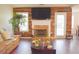 Cozy living room features wood floors, a fireplace with mantel, and a sliding glass door that provides plenty of natural light at 3851 Bogan Mill Rd, Buford, GA 30519